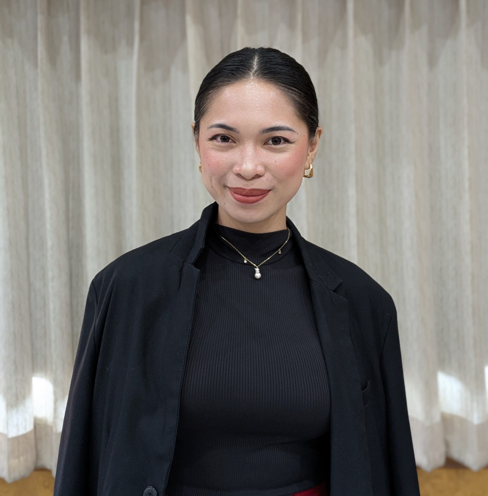 Emma, English speaking coach, smiling in a black blazer